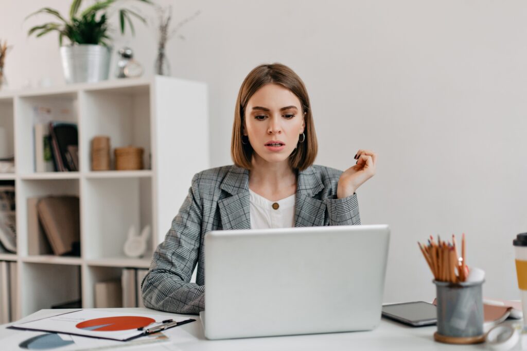 Focused businesswoman working on a sleek laptop in a modern office setting, ideal for illustrating a professional MacBook Air M3 review in 2025.