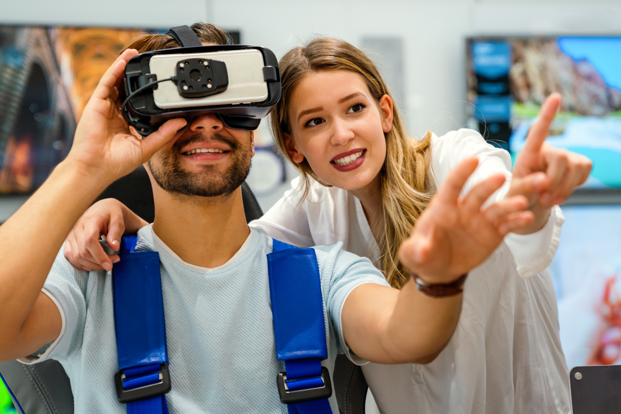 A couple testing a virtual reality experience in a modern showroom, highlighting the innovation and customer engagement of a leading Florida tech company.

