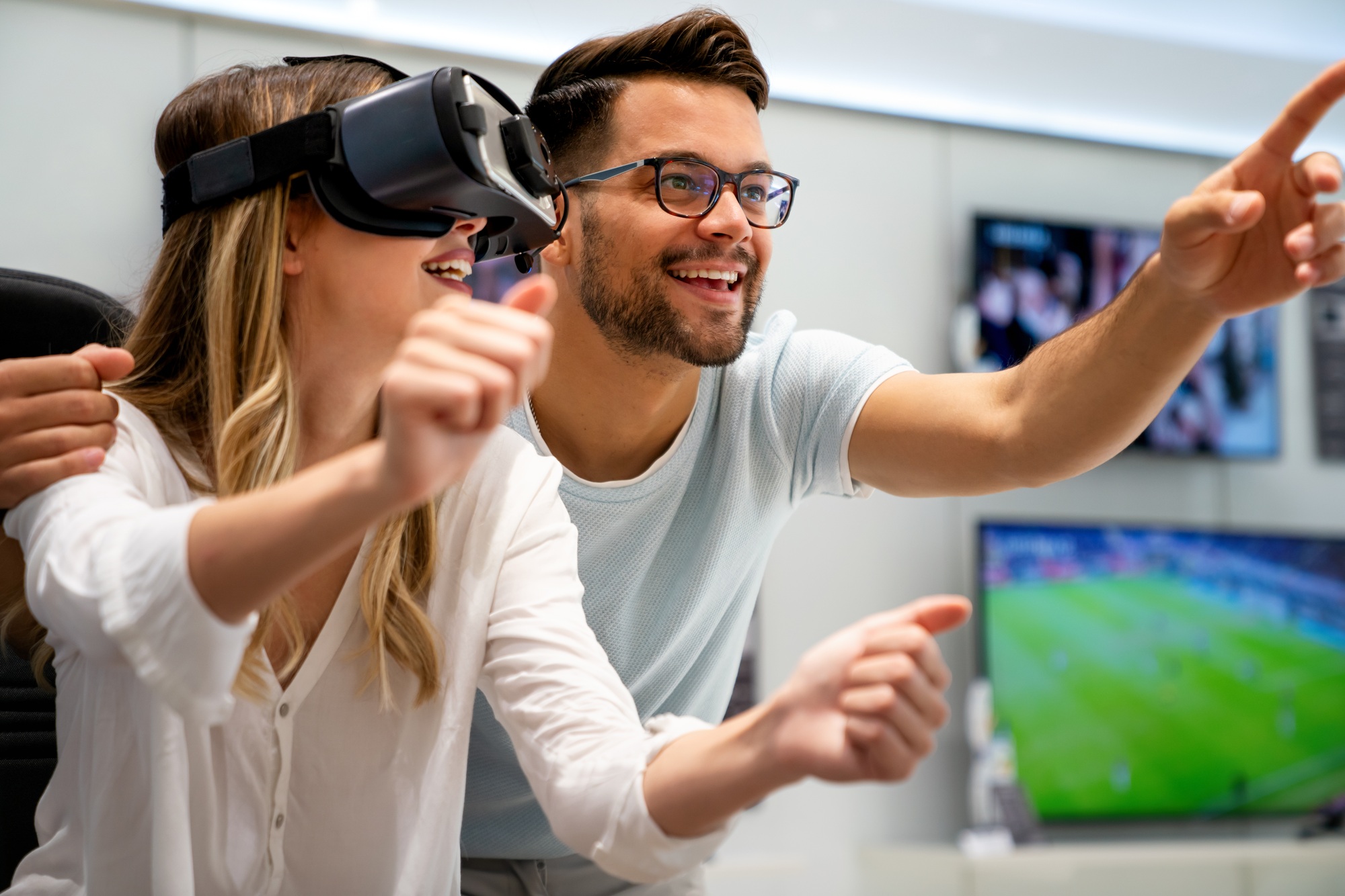 A couple enjoying an immersive VR experience at a tech retail store — showcasing innovation and interactivity at UnitedTech Deals company.

